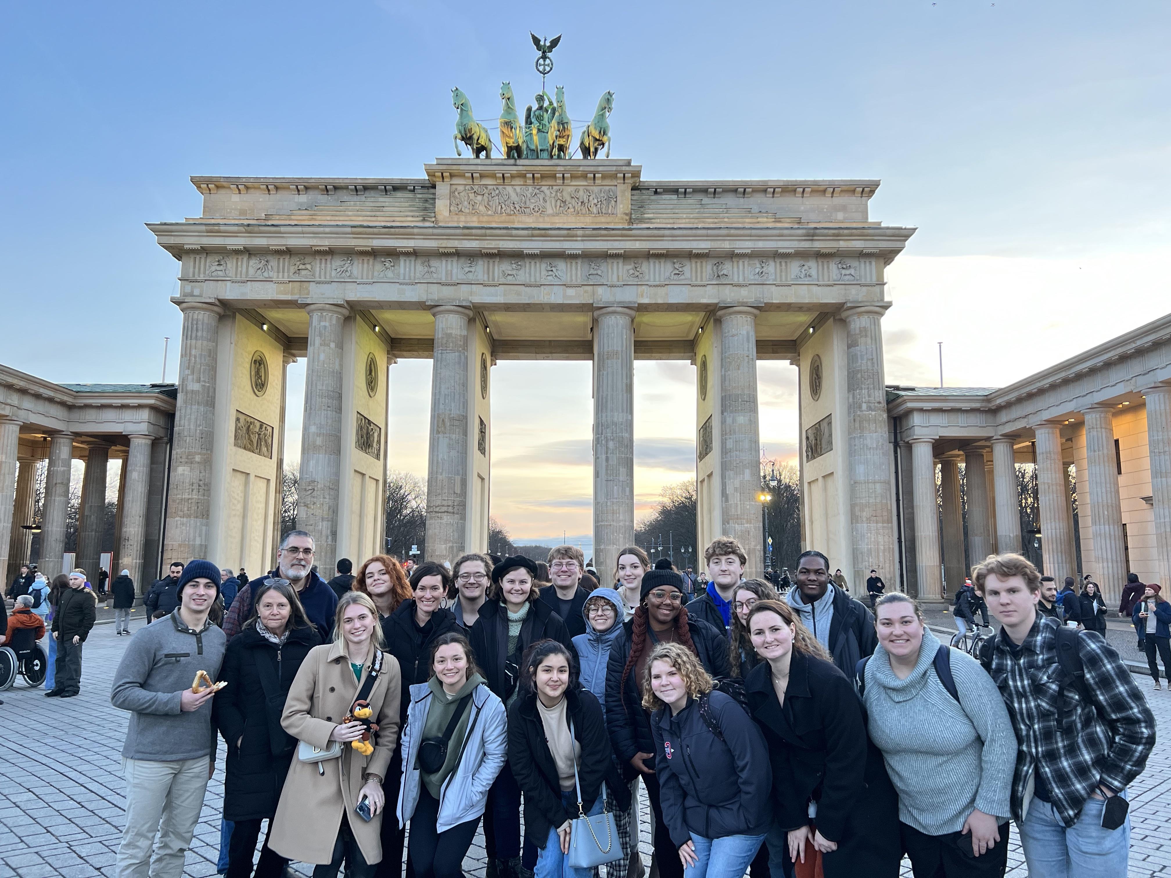 Honors students studying abroad in Germany standing in front of the Brandenburg Gate in Berlin